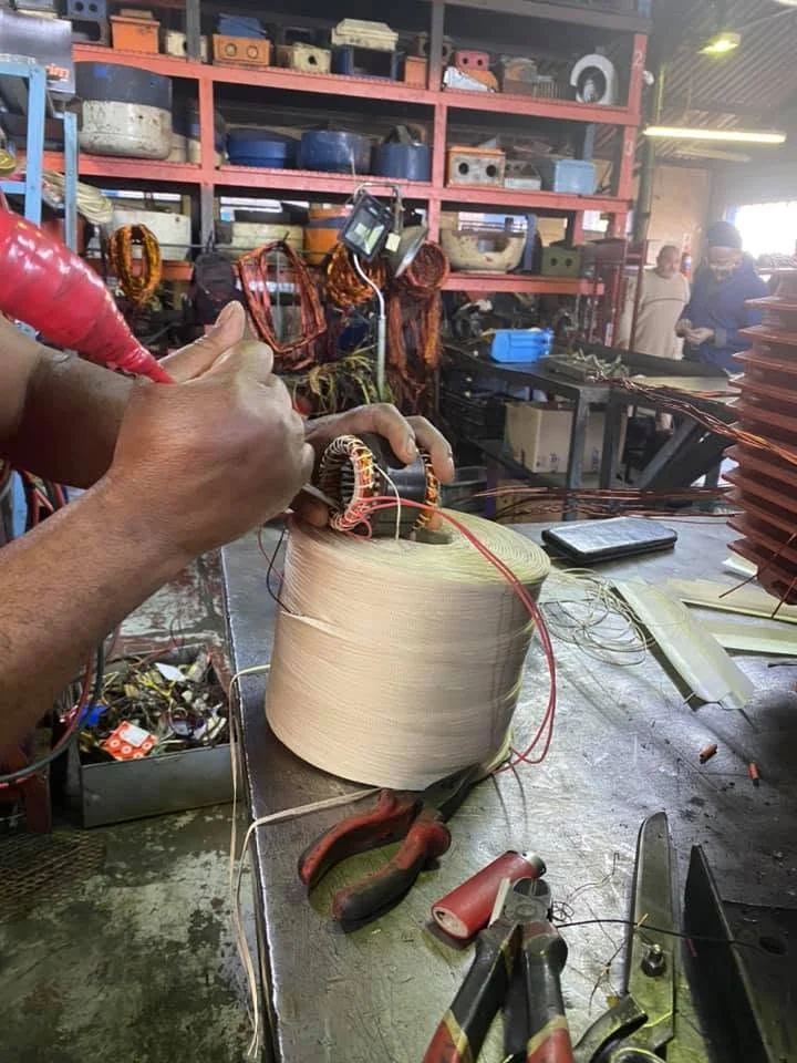 Hands working on electrical equipment in the Granlor workshop